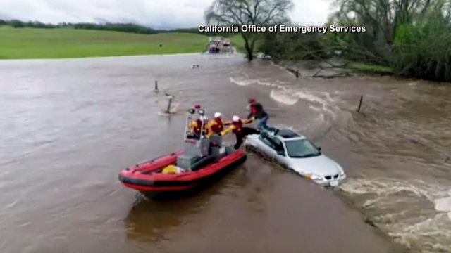 Raw: Crews pull CA driver from vehicle, swollen creek