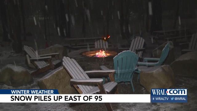 Snow continues to pile up east of Interstate 95