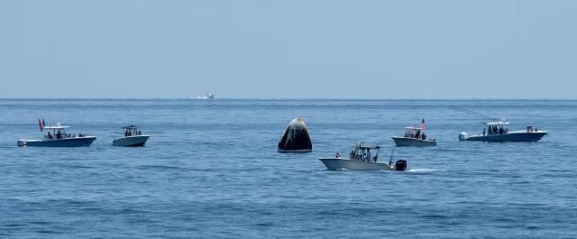 curious recreational boaters arrive at the SpaceX Crew Dragon Endeavour spacecraft shortly after splashdown
