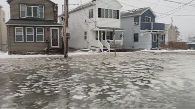 Winter storm floods Mass. streets, boats stuck frozen in marina 