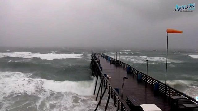 Live conditions: Raging waves pound the pier at Kill Devil Hills, NC