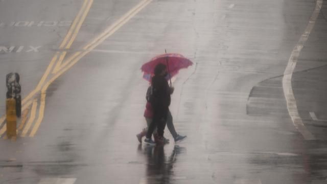 People cross the street with umbrellas in heavy rain in Los Angeles, Monday, Feb. 19, 2024. (AP Photo/Damian Dovarganes) People cross the street with umbrellas in heavy rain in Los Angeles, Monday, Feb. 19, 2024. (AP Photo/Damian Dovarganes)