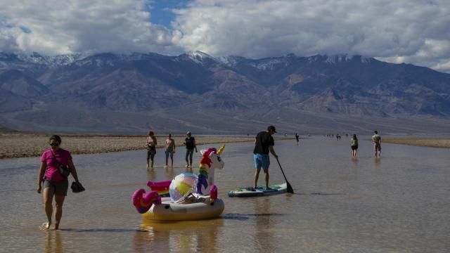 A paddle boarder tows an inflatable unicorn on a temporary lake in Death Valley on Thursday, Feb. 23, 2024, in Death Valley National Park, Calif. A series of storms have brought more than double the parks annual rainfall in the past six months. (AP Photo/Ty ONeil) A paddle boarder tows an inflatable unicorn on a temporary lake in Death Valley on Thursday, Feb. 23, 2024, in Death Valley National Park, Calif. A series of storms have brought more than double the parks annual rainfall in the past six months. (AP Photo/Ty ONeil)