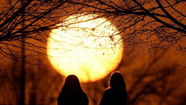 People watch the sunset at a park on an unseasonably warm day, Sunday, Feb. 25, 2024, in Kansas City, Mo. A warm front is sweeping springlike weather across a large swath of the country in what is usually one of the coldest months of the year. (AP Photo/Charlie Riedel) People watch the sunset at a park on an unseasonably warm day, Sunday, Feb. 25, 2024, in Kansas City, Mo. A warm front is sweeping springlike weather across a large swath of the country in what is usually one of the coldest months of the year. (AP Photo/Charlie Riedel)