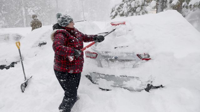 Janna Gunnels digs out her car along North Lake Boulevard as snow continues to fall in Tahoe City, Calif., on Saturday, March 2, 2024. (Jane Tyska/Bay Area News Group via AP)
