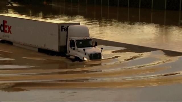 A truck drives through flooded road in Chattanooga, Tenn., Tuesday, Aug. 12, 2025. (WTVC via AP)