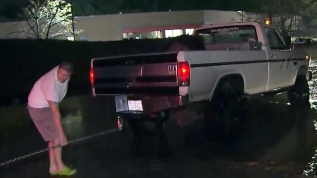Men stage truck rescue from flooded Raleigh street