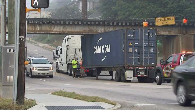 RAW: Crews free truck stuck under Peace Street bridge