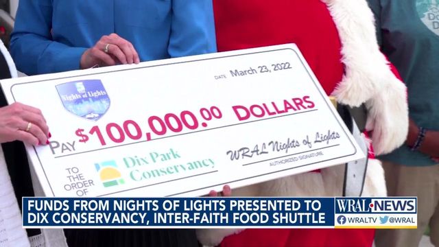 Santa helps deliver money raised by WRAL Nights of Lights to food bank, Dix Park