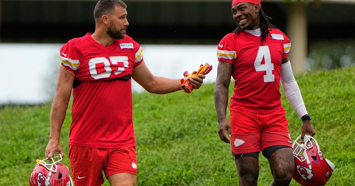 Kansas City Chiefs tight end Travis Kelce (87), and wide receiver Rashee Rice (4) walk to NFL football training camp Friday