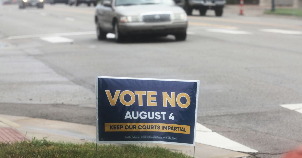 A sign encourages voters to reject a proposal to change how Kanas Supreme Court justices are seated in Topeka, Kan., on