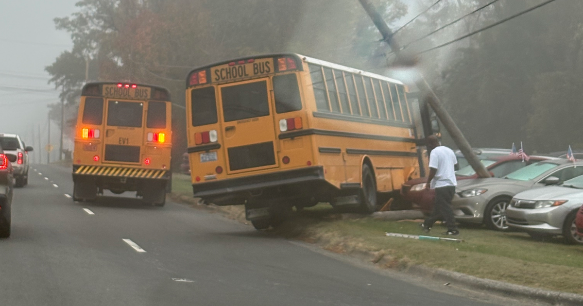 School bus crashes into utility pole at Durham car dealership