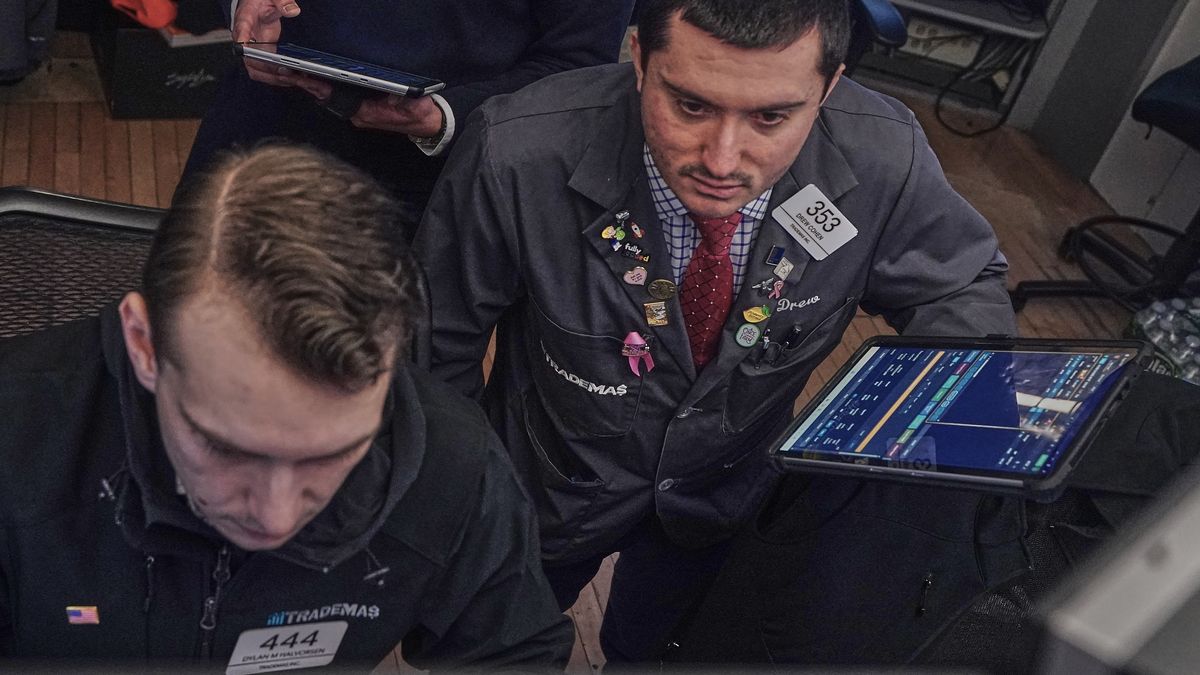 Traders Dylan Halvorsan, left, and Drew Cohen work on the floor of the New York Stock Exchange, Friday, Feb. 13, 2026, in New York. (AP Photo/Richard Drew)