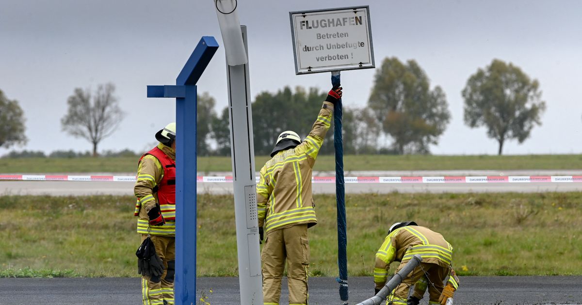 German authorities investigate a hole cut into a fence at Leipzig airport