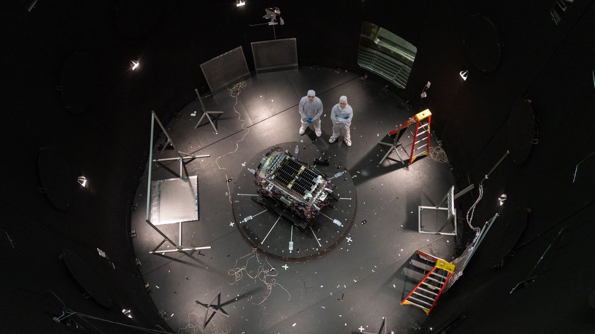 This photo provided by NASA shows Kieran Wilson, LINK’s principal investigator, and Hunter Robertson, a space systems engineer, both at Katalyst Space, standing next to their spacecraft inside the SES (Space Environment Simulator) at NASA’s Goddard Space Flight Center in Greenbelt, Md., April 17, 2026, ahead of thermal vacuum testing. (Sophia Roberts/NASA via AP)