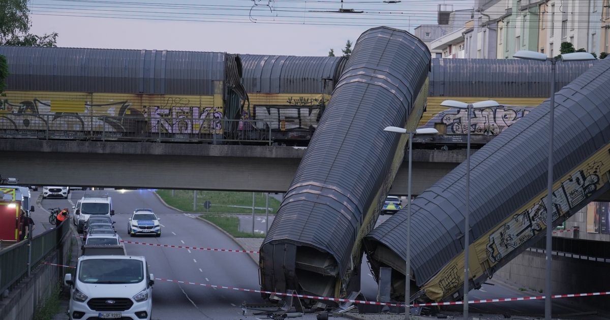 Freight trains' collision in Germany sends 2 wagons plunging off a bridge. One person was killed