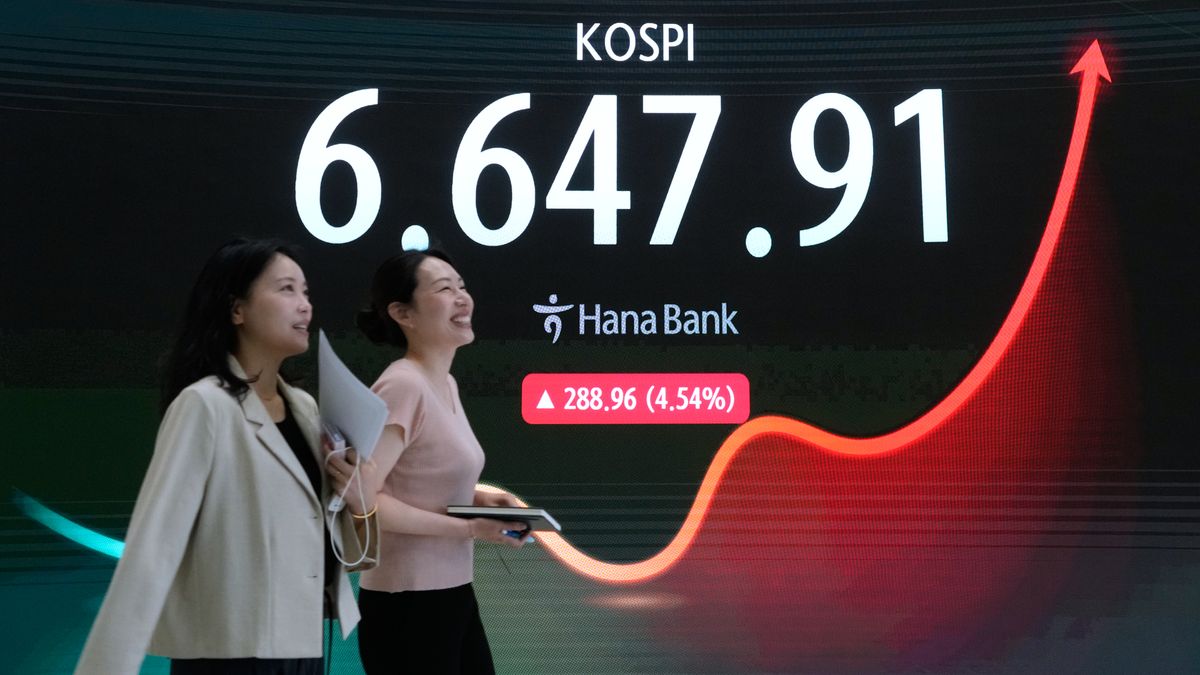 Currency traders pass by a screen showing the Korea Composite Stock Price Index (KOSPI) at the foreign exchange dealing room of the Hana Bank headquarters in Seoul, South Korea, Wednesday, Aug. 5, 2026. (AP Photo/Ahn Young-joon)