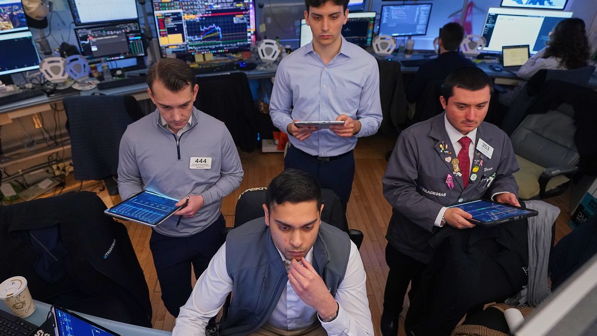 Niall Pawa, foreground center, works with fellow traders on the floor of the New York Stock Exchange, Monday, June 1, 2026. (AP Photo/Richard Drew)