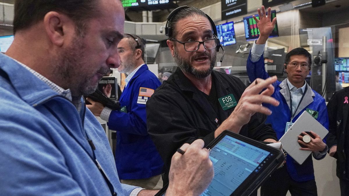 Chris Dattolo, center, works with fellow options traders on the floor of the New York Stock Exchange, Thursday, Jan. 22, 2026. (AP Photo/Richard Drew)